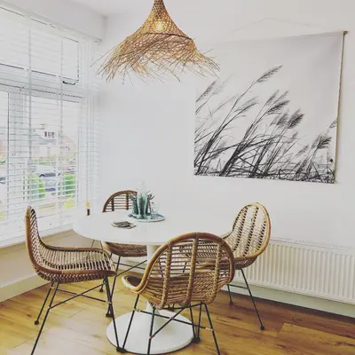 a dining room with a table and chairs at Appartement Zuyd in Zandvoort