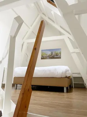 two beds in a room with white ceilings at Hotel Residence Le Coin in Amsterdam