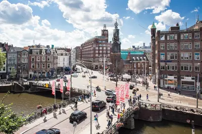 a city street with a bridge and buildings at Hotel Residence Le Coin in Amsterdam