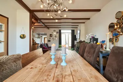 a dining room table with candles on top of it at Family home in Edam