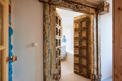 an old door in a hallway with a bathroom at Family home in Edam