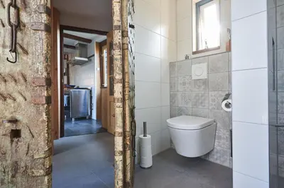 a bathroom with a toilet and a window at Family home in Edam