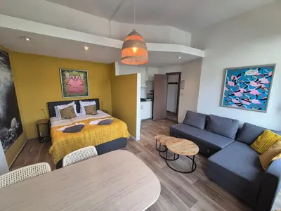 a hotel room with a bed and a couch at Amsterdam Beach House in Zandvoort