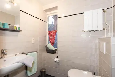 a bathroom with a sink and a toilet at Bed and Breakfast De Pepersteeg in Marken