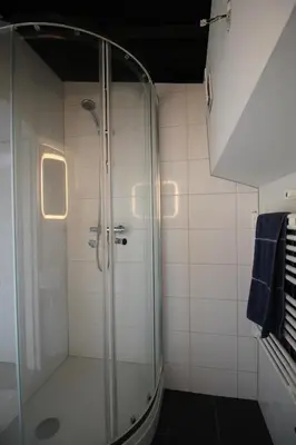 a shower in a bathroom with a glass shower stall at studio Vincent van Gogh in Amsterdam