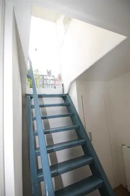 a blue staircase in a building with a window at studio Vincent van Gogh in Amsterdam