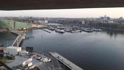 an aerial view of a harbor with boats in the water at studio Vincent van Gogh in Amsterdam