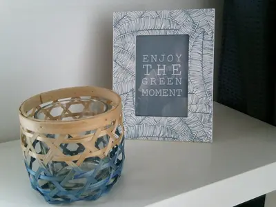 a blue vase sitting on a table next to a book at BedStay41 in Oudewater