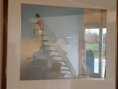 a painting of a person walking up a staircase in a house at BedStay41 in Oudewater