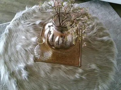 a vase with flowers in it sitting on a rug at BedStay41 in Oudewater