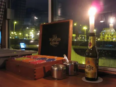 a bottle of wine sitting next to a wooden box at Passengership Avanti in Amsterdam