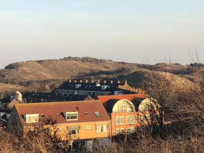 a group of houses on a hill with a train at Beach-house27 in Egmond aan Zee