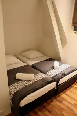 two twin beds in a room with an attic at Central sweet BNB in Amsterdam