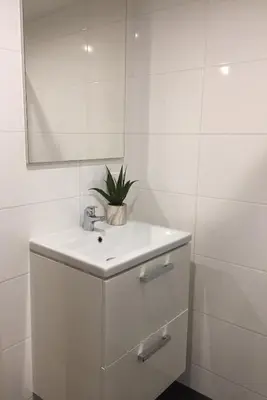 a white bathroom with a sink and a mirror at Central sweet BNB in Amsterdam