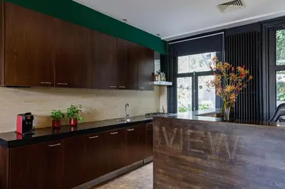 a kitchen with wooden cabinets and a counter top at Boutique Hotel View in Amsterdam