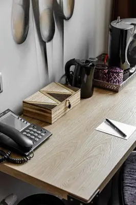 a desk with a telephone and a coffee maker on it at Boutique Hotel View in Amsterdam