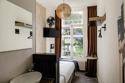 a hotel room with a bed and a window at Boutique Hotel View in Amsterdam