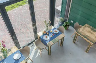 a table and chairs sitting on a balcony with a table and chairsktop at De Groene Bollenschuur in Hillegom