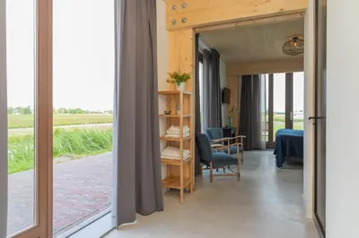 a room with a view of a room with a table at De Groene Bollenschuur in Hillegom