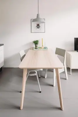 a wooden table and chairs in a room at Kranenbergh Boutique Apartments in Bergen