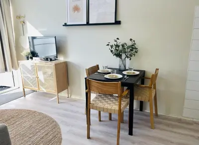 a dining room with a black table and chairs at Kranenbergh Boutique Apartments in Bergen