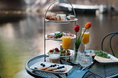 a table with a tray of food and drinks at Amsterdam Canal Hotel in Amsterdam