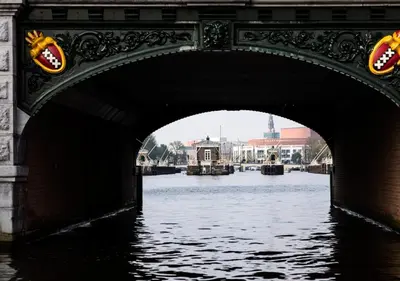 a bridge over a body of water at SWEETS - Amstelschutsluis in Amsterdam