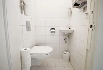 a white bathroom with a toilet and a sink at White Luxury Penthouse in City Centre in Amsterdam