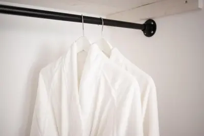 a white shirt hanging on a curtain rod at Achter de duinen in Zandvoort