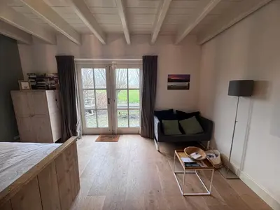 a room with a bed and a couch and a table at Ora et Labora in Beets
