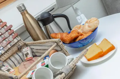 a table with a bowl of bread and a bowl of cheese at B&B Blossom in Lisse