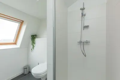 a bathroom with a shower and a toilet at B&B Blossom in Lisse
