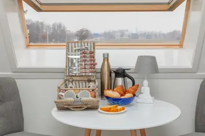 a table with a basket of croissants and a basket of bread at B&B Blossom in Lisse