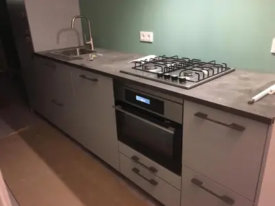 a kitchen with a stove top oven next to a sink at Amsterdam Beach Home 46 in Zandvoort