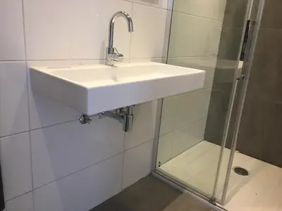 a bathroom with a sink and a shower at Amsterdam Beach Home 46 in Zandvoort