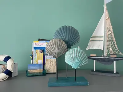a table with two figurines of a boat and a sail at Amsterdam Beach Home 46 in Zandvoort