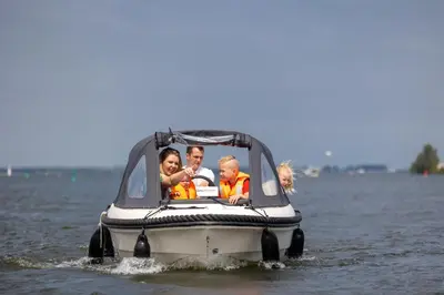 a group of people on a boat in the water at RCN Zeewolde in Zeewolde