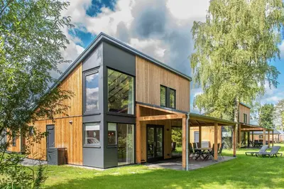 a modern house with a black roof and windows at RCN Zeewolde in Zeewolde