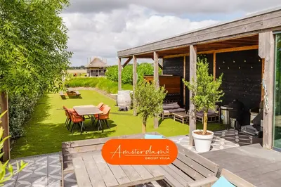an outdoor patio with a table and chairs at Amsterdam Group Villa 20 plus beds 4 - 5 bedrooms in Zwanenburg