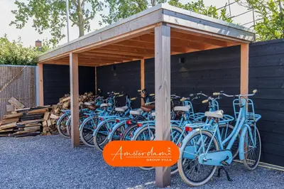 a group of blue bikes parked under a building at Amsterdam Group Villa 20 plus beds 4 - 5 bedrooms in Zwanenburg