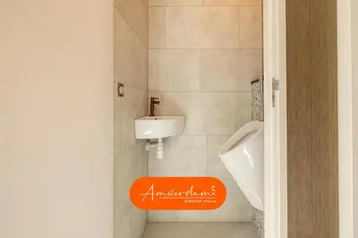 an orange sign in a bathroom with a sink at Amsterdam Group Villa 20 plus beds 4 - 5 bedrooms in Zwanenburg