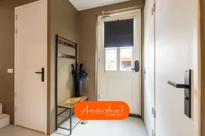 an orange bench in front of a door at Amsterdam Group Villa 20 plus beds 4 - 5 bedrooms in Zwanenburg