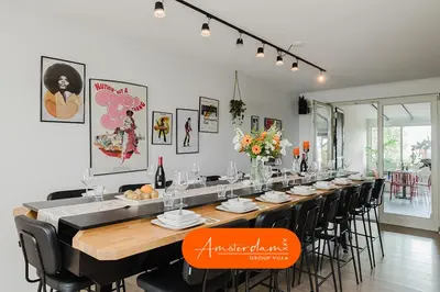 a long dining room with a long table and chairs at Amsterdam Group Villa 20 plus beds 4 - 5 bedrooms in Zwanenburg