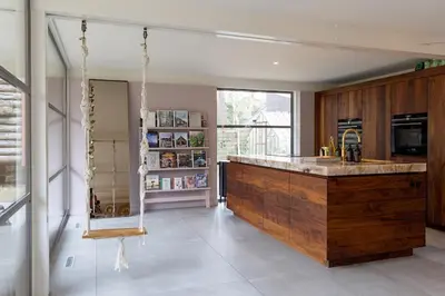 a large kitchen with a large wooden counter top at Villa in the forest near the beach in Bergen