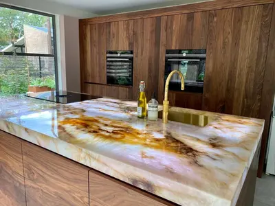 a kitchen with a marble counter top with a sink at Villa in the forest near the beach in Bergen