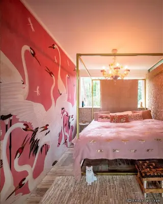 a bedroom with a bed with birds painted on the wall at Villa in the forest near the beach in Bergen