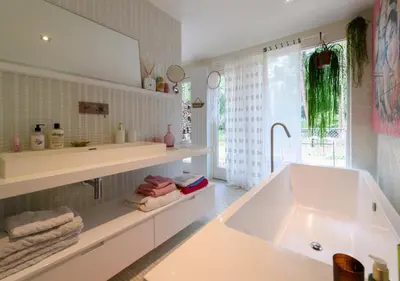 a bathroom with a large tub and a sink at Villa in the forest near the beach in Bergen