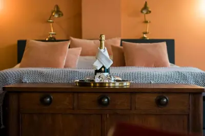 a bedroom with a bed with a wooden dresser with a bed sqor at De Buren in Vleuten