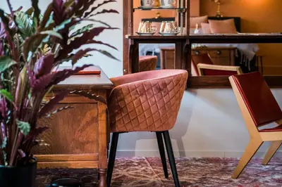 a desk with a chair next to a plant at De Buren in Vleuten