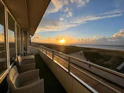 a balcony with chairs and a view of the ocean at Appartementen Zeezicht - 1 in Katwijk aan Zee